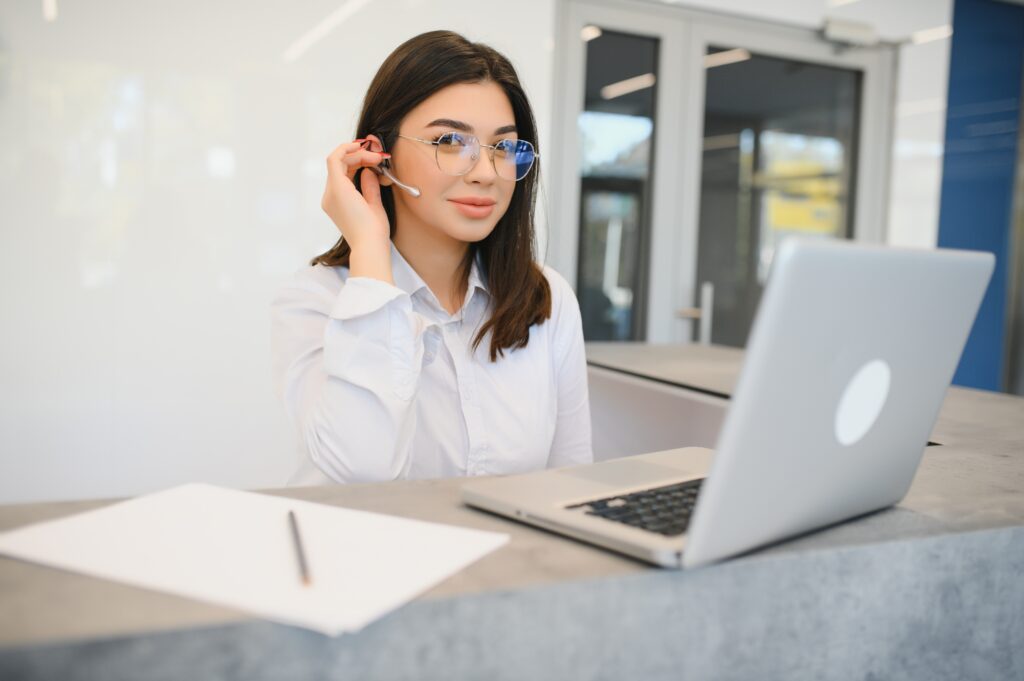 Young female receptionist working in office | Cobalt Digital Marketing A business receptionist ready to respond to leads